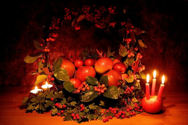 Still life with hawthorn, apples and burning candles