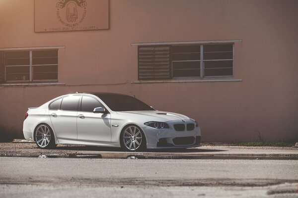 White bmw 550i front view