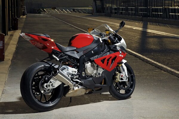 Red sport bike on gray asphalt