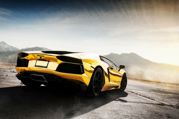 Golden Lamborghini car on the background of mountains