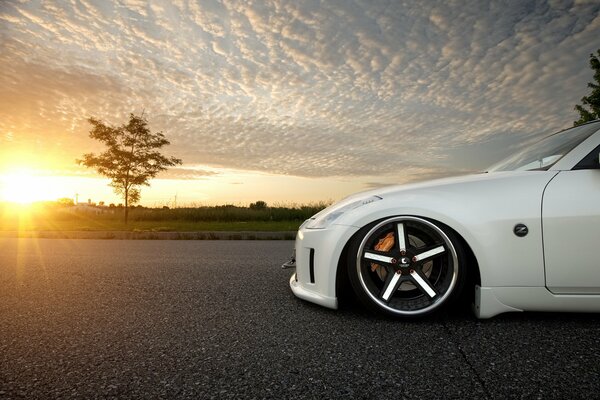 White understated Nissan 350z on the background of a beautiful sunset