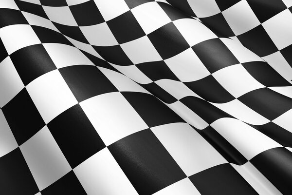 A checkered flag fluttering in the wind made of black and white squares