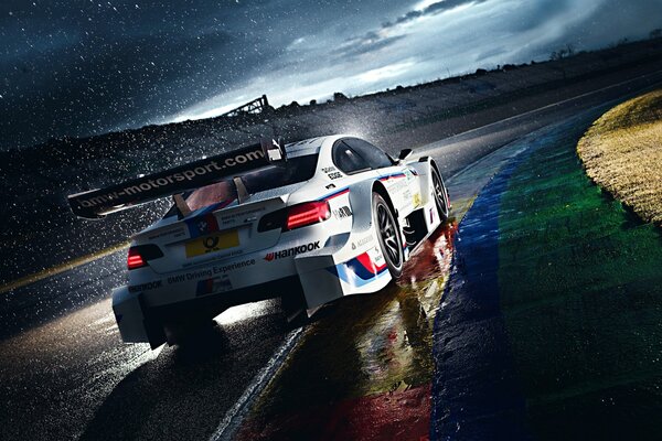 White bmw racing in the morning rain