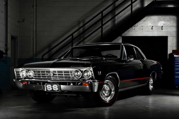 In the semi-dark garage, a Chevrolet car