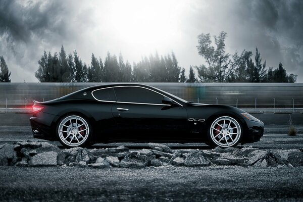 Black maserami rides on the road