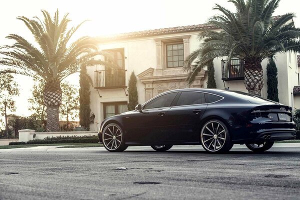 Audi a7 driving along beautiful houses