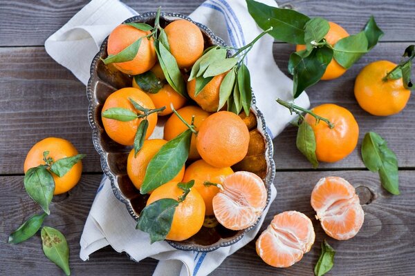 Bright juicy tangerines in a towel