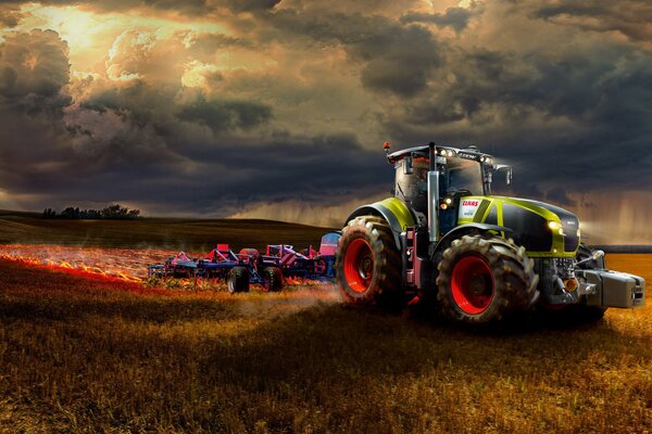 Tracteur urbain dans le champ au coucher du soleil