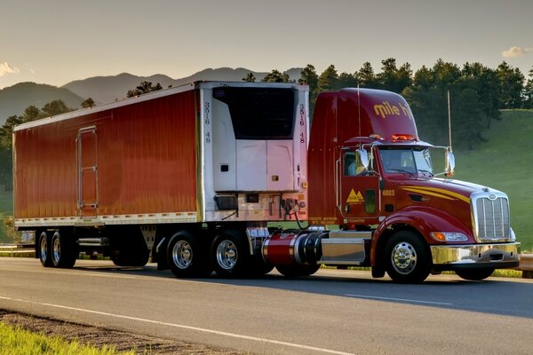 Peterbilt truck on the road against the background of mountains