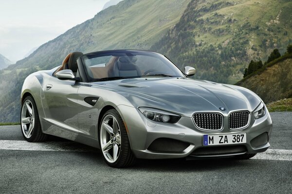 Silver BMW in the mountains under a blue sky