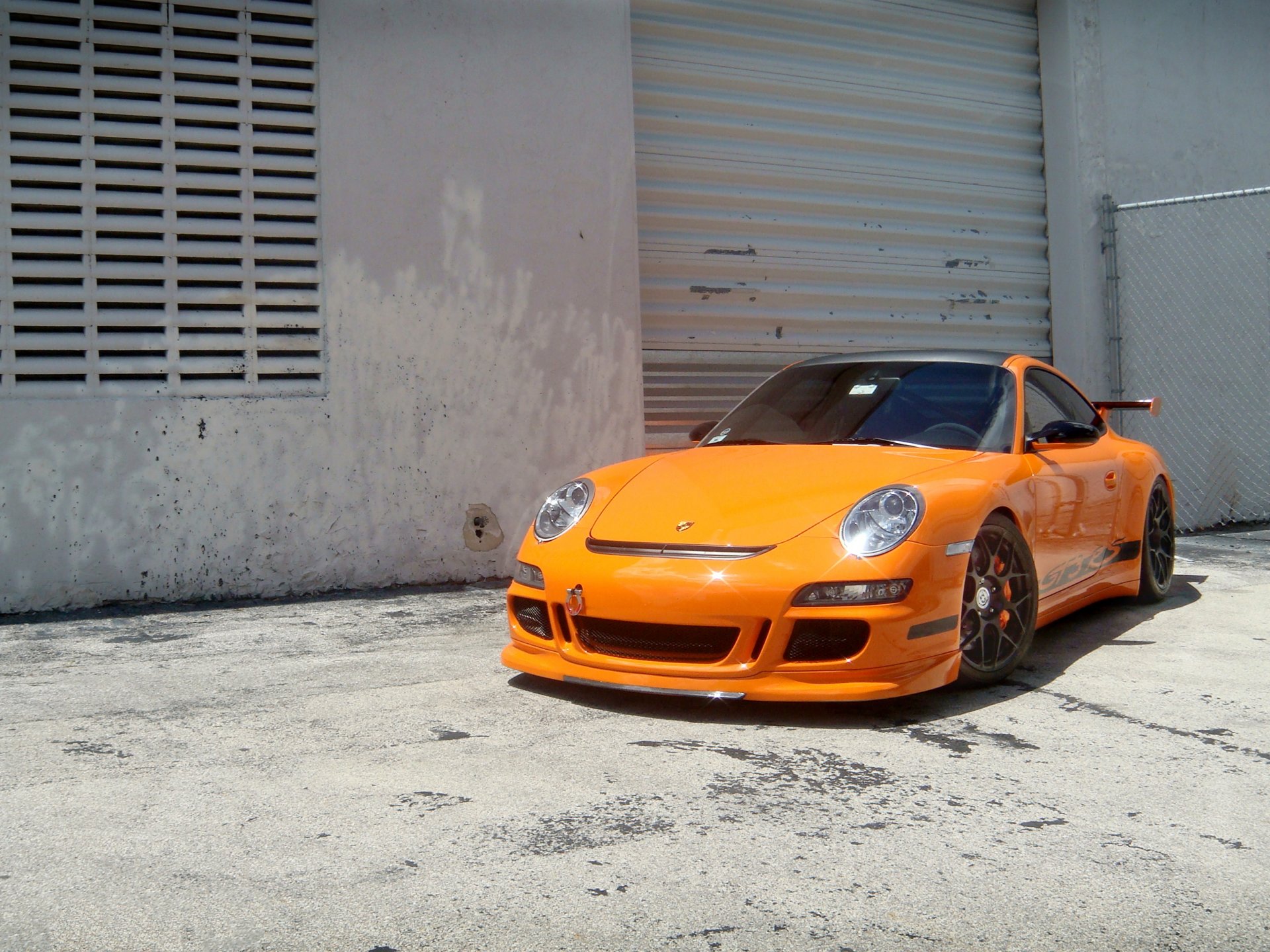 porsche gt3 rs orange wheels porsche gt3 rs building wall fence roller shutter