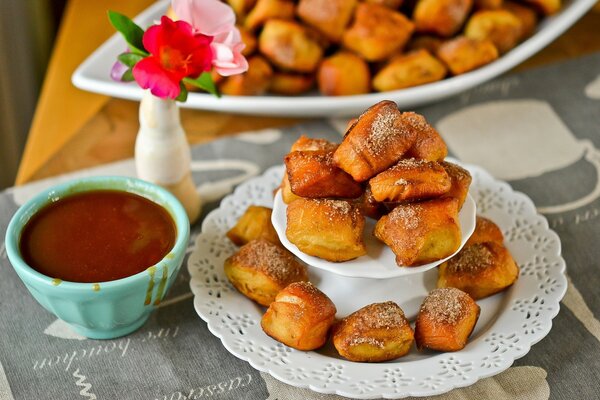 A buffet of pastries with flowers on a beautiful dish