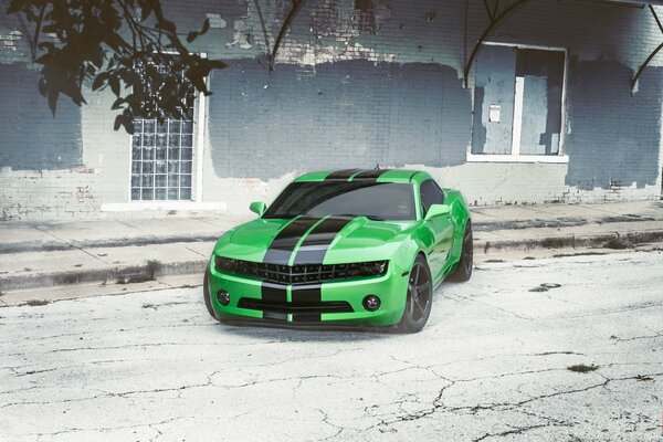 Green Chevrolet on the background of an old building