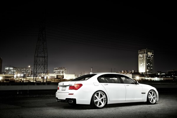 BMW blanco en el fondo de la ciudad de la noche