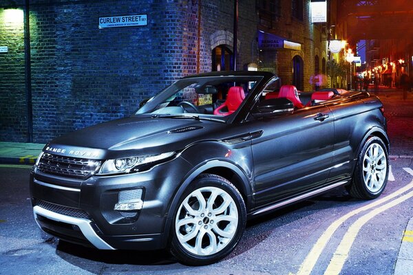 Steel range rover on a night European street