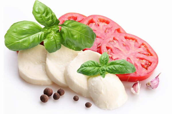 Slicing cheese tomatoes and basil leaves