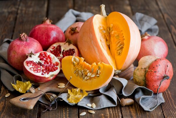 Still life of pomegranates and pumpkins