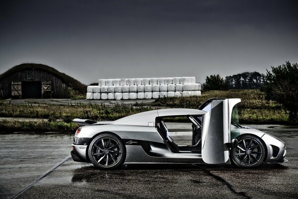 Silver supercar with an open door