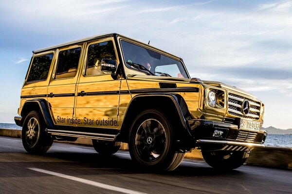 Yellow Gypsy Mercedes Benz on the road