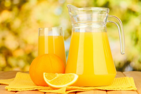 Freshly squeezed juice in a decanter on a yellow towel