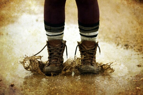 The legs of a child who jumped into a puddle