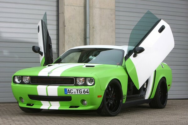 The car is parked at garages with open doors