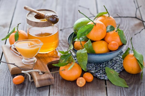 Citrus fruits and honey on a wooden table