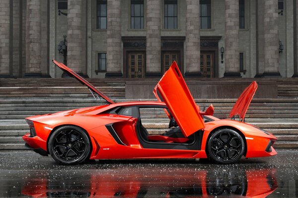 Orange lamborghini aventador LP700-4 in front of the building