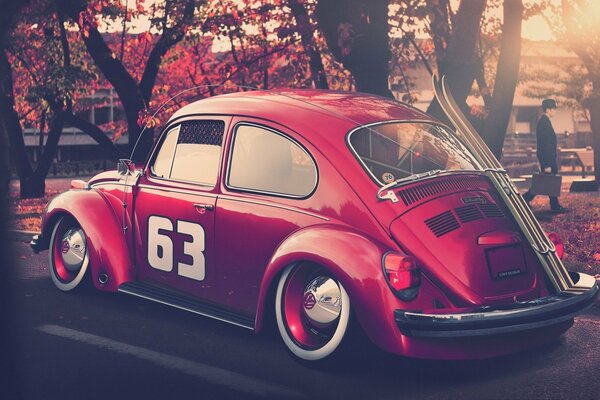 Red Volkswagen retro on the road in autumn