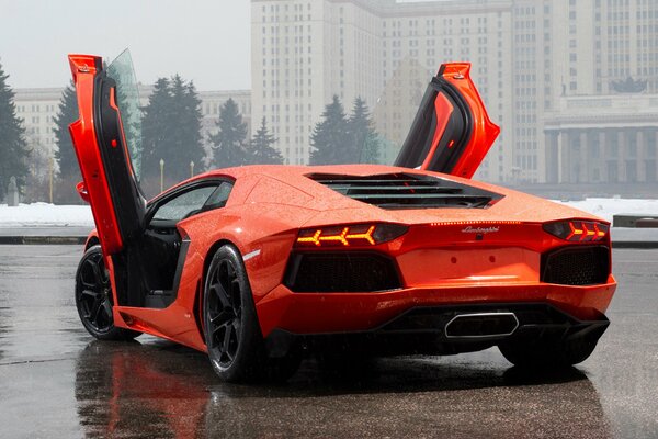 Orange Lamborghini Aventador LP700-4, rear view with open wing doors