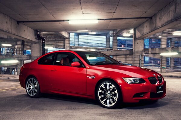 Red BMW at the entrance to the garage