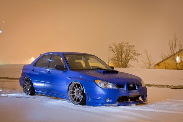 Blue Subaru car in the snow