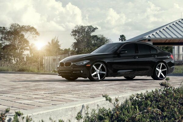 Bmw 3 series on the background of a country house