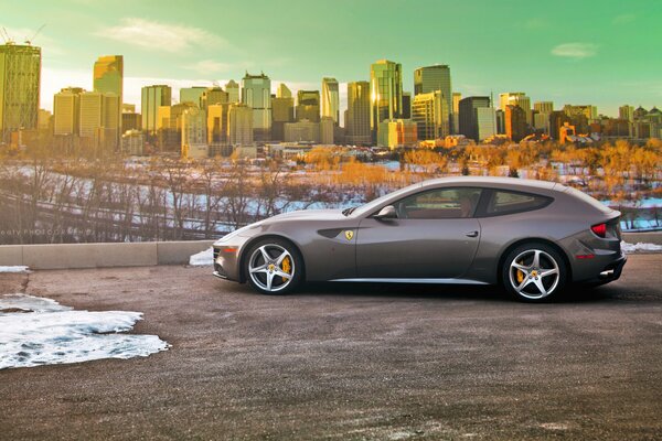 Ferrari in winter weather against the background of the city