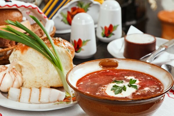 Ukrainian food borscht , lard and green onions on the table