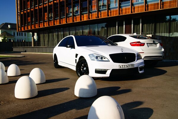 Two white luxury Mercedes on the street