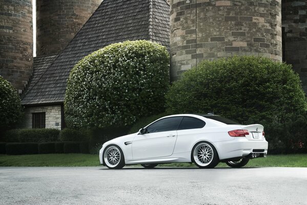 White car on the background of a house with towers