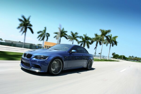 Blue sports car mchitch on sunny streets