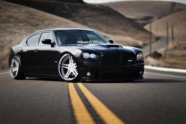 A black car on a blurry road background