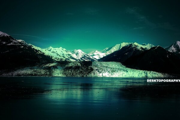 Mountains in the snow. Lake in winter