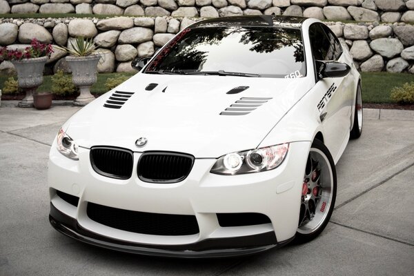 A white BMW with metal wheels looks great