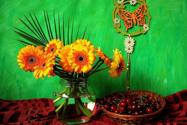 Mise en scène de chrysanthèmes et de cerises sur fond vert