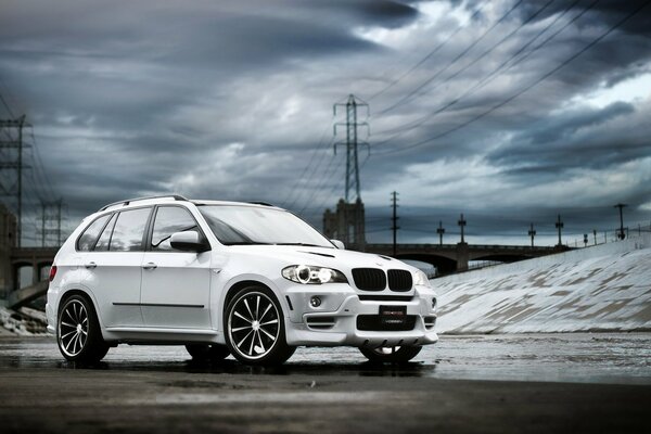 White bmw x5 car on the background of clouds