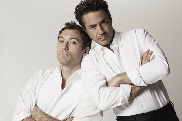 Robert Downey Jr. and Jude Law in white shirts, with rejected sleeves