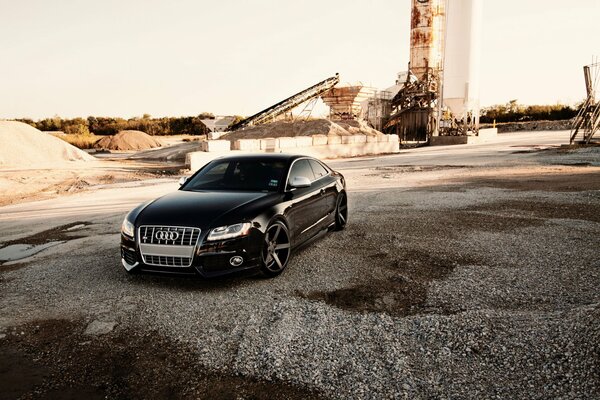 A black car on a concrete block construction site