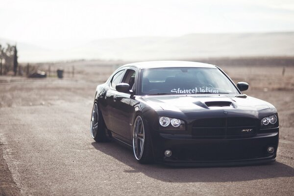 Dodge sedan rides through the desert