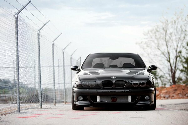 Black BMW car near the school