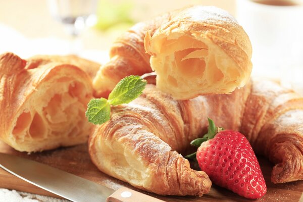 Baking with strawberries on a board next to a knife