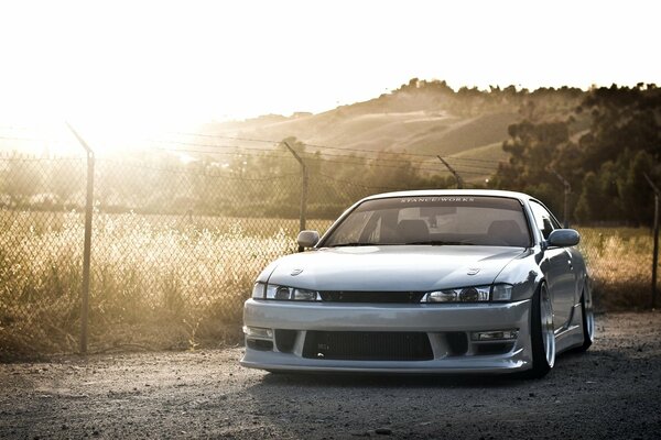 Silver Nissan drifts on the road