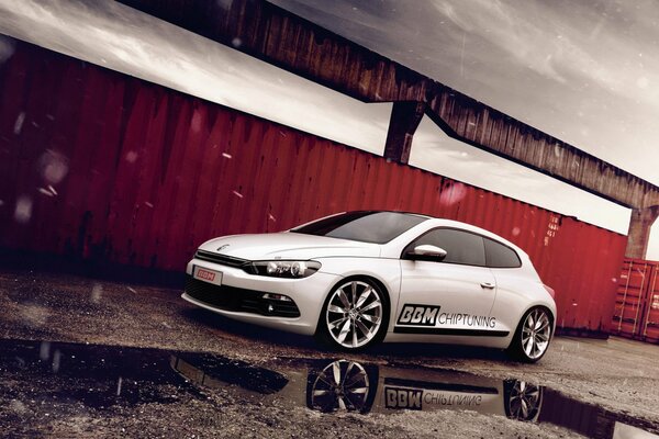 Volkswagen tuning scirocco and its reflection in a puddle